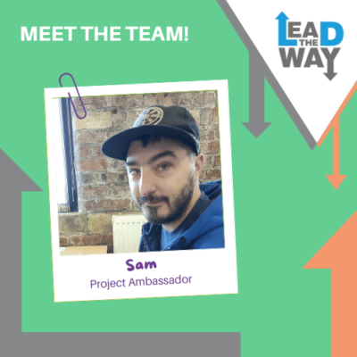 A Green background with orange and grey arrows was used as decoration on this poster. Lead the Way logo on the right side of the poster. On the left side of the poster is an image of Sam: a man with facial hair. The Image also shows his name: Sam and his job role, Project Ambassador.